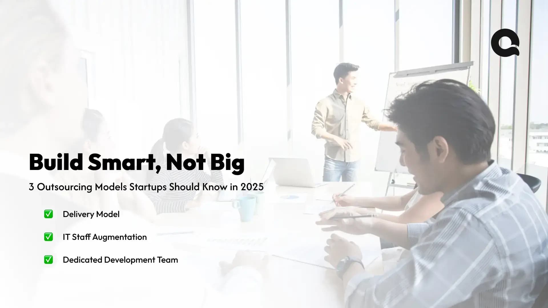 Startup team discussing custom software outsourcing models for 2025 in a collaborative workspace.