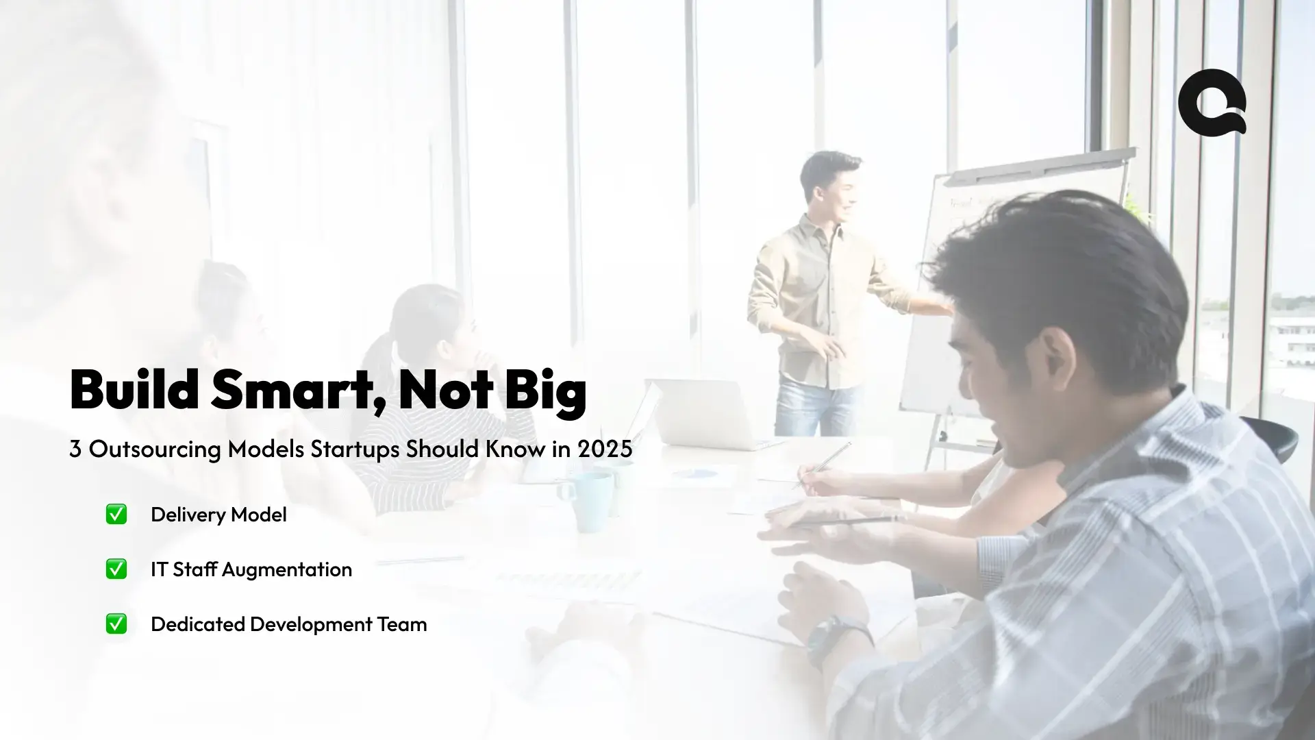 Startup team discussing custom software outsourcing models for 2025 in a collaborative workspace.
